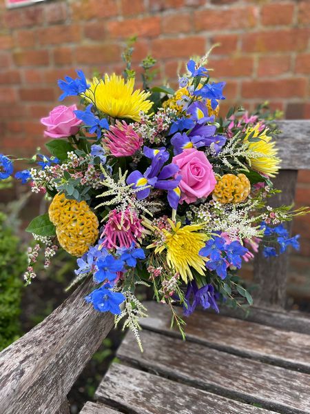 Vibrant a florist choice bright coloured blooms create this handtied. Order online for your next day flower delivery. Bishops Stortford